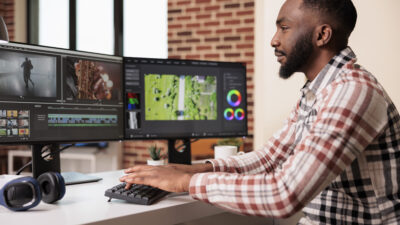 Graphic artist editing film footage on software stock photo