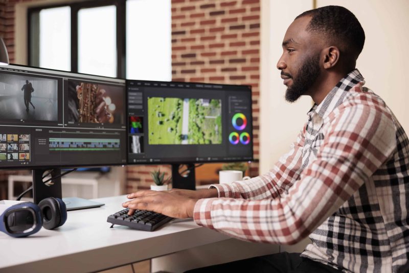 Graphic artist editing film footage on software stock photo