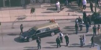 Hearse in Chicago surrounded by police after a shooting at a funeral - screenshot