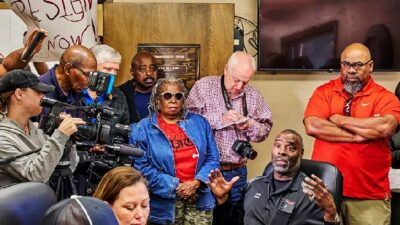 Idabel, Oklahoma, Mayor Craig Young, seated right, speaks at the McCurtain County Commissioners meeting Monday. Residents are calling for the resignation of several McCurtain County officials after they were allegedly heard making racist and threatening comments in an audio recording (Christopher Bryan-Southwest Ledger-AP)