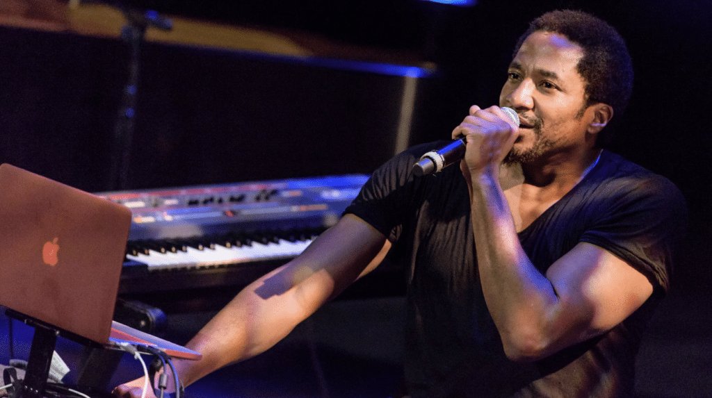 Birthday Boy Q-Tip of A Tribe Called Quest sits behind a keyboard