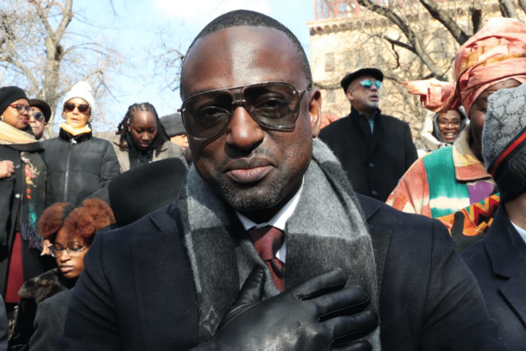 Yusef Salaam in sunglasses with gloved hand over his heart