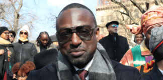 Yusef Salaam in sunglasses with gloved hand over his heart