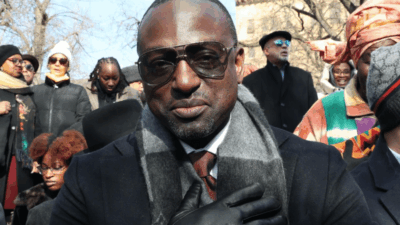 Yusef Salaam in sunglasses with gloved hand over his heart