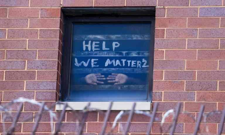 A sign on the window at the Cook County Jail complex reads, "Help, We Matter 2"