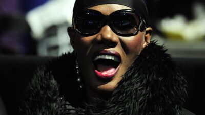 Grace Jones in head scarf and sunglasses