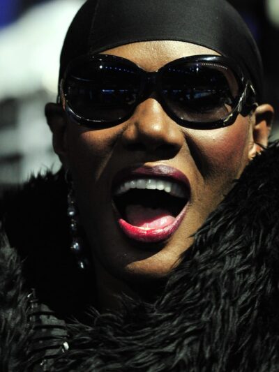 Grace Jones in head scarf and sunglasses