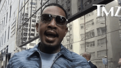 Bill Bellamy is interviewed outside of a building by TMZ