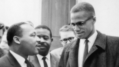 cropped: Martin Luther King Jr. and Malcolm X waiting for a press conference on March 26, 1964.