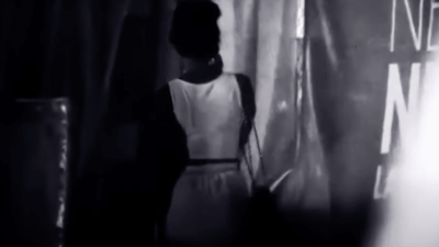 Black woman walks down a street
