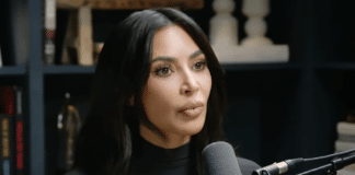 Kim Kardashian speaks into a microphone on the Jay Shetty podcast "On Purpose"