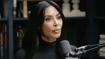 Kim Kardashian speaks into a microphone on the Jay Shetty podcast "On Purpose"
