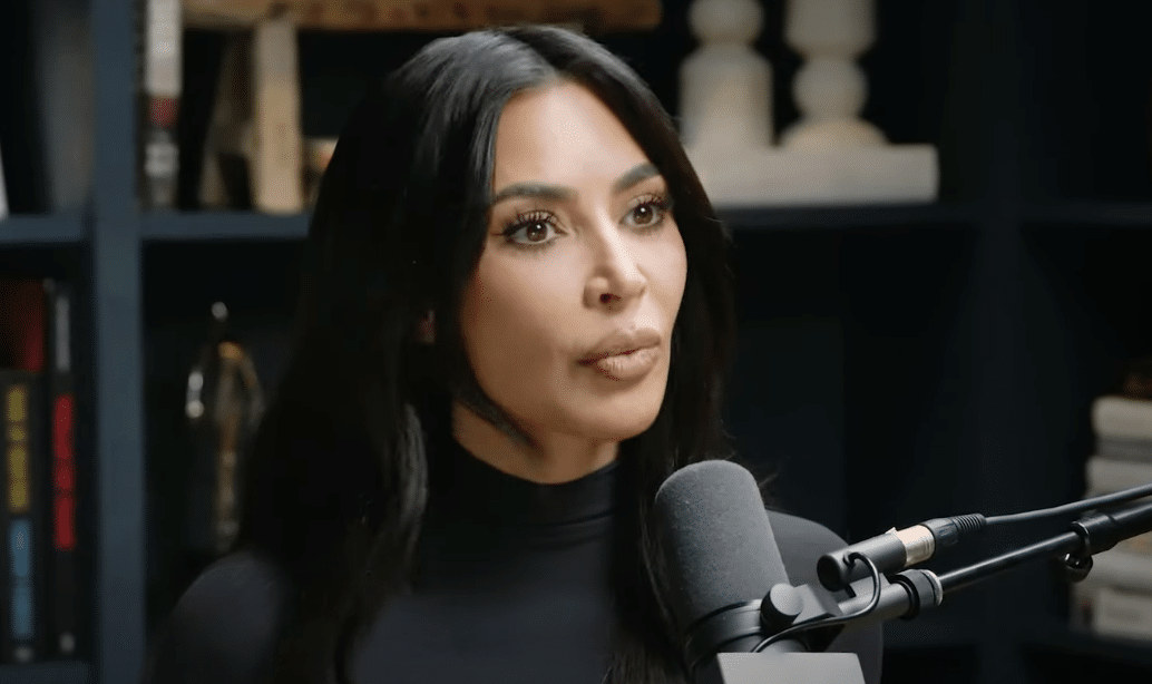 Kim Kardashian speaks into a microphone on the Jay Shetty podcast "On Purpose"
