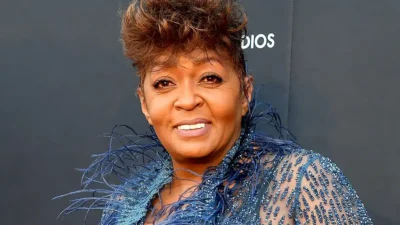 Anita Baker smiles on a red carpet