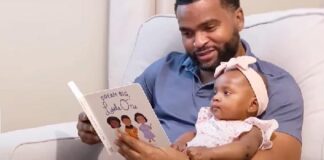 Black Father reading book to baby daughter - screenshot