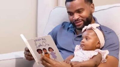 Black Father reading book to baby daughter - screenshot
