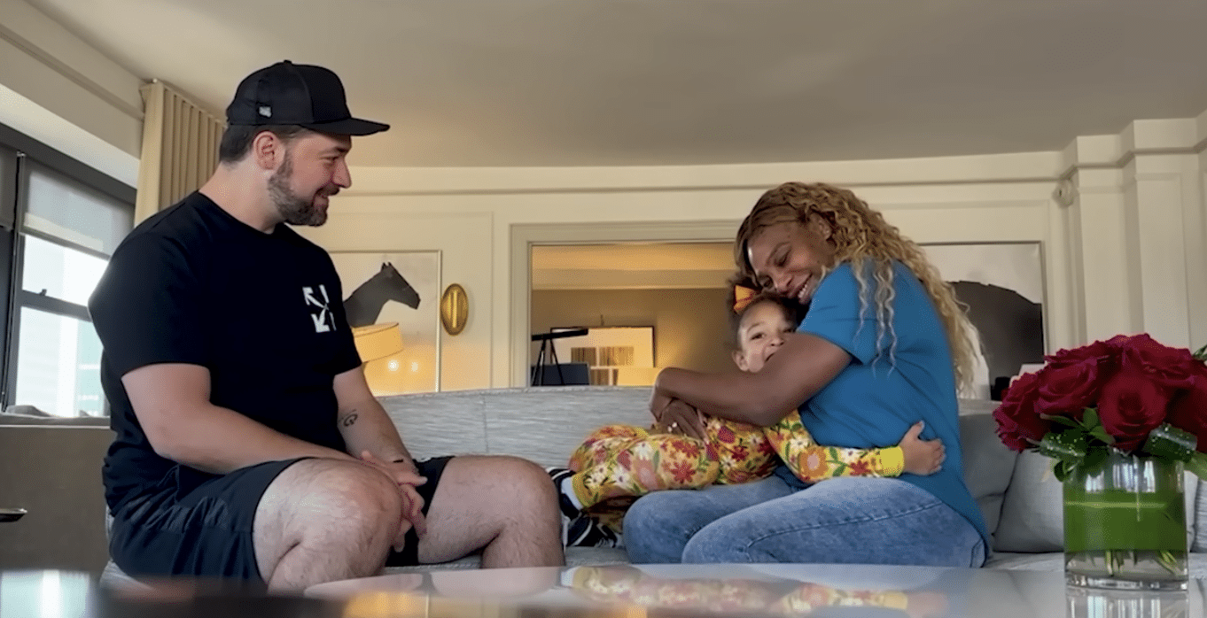 Alexis Ohanian and Serena Williams sit on their couch with daughter Alexis Olympia