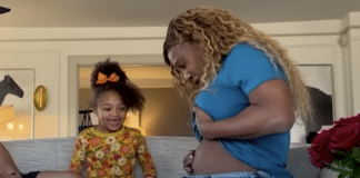 Serena Williams shows off her baby bump to daughter Olympia on their sofa