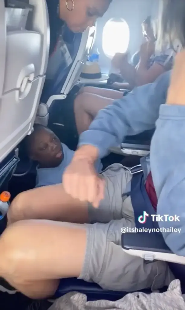 unruly passenger spitting on people