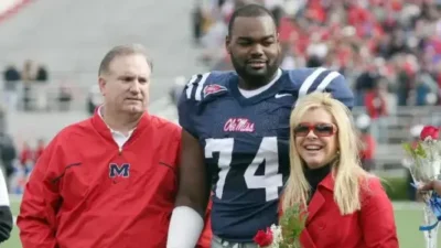 Michael Oher with Sean and Leigh Anne Tuohy (Matthew Sharpe-Getty Images)