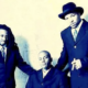 Something For the People pose in suits for a publicity photo