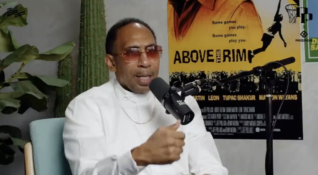 Stephen A. Smith, in a white button-down and red-tinted sunglasses, speaks on the "Podcast P with Paul George: podcast