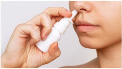 woman using nasal spray