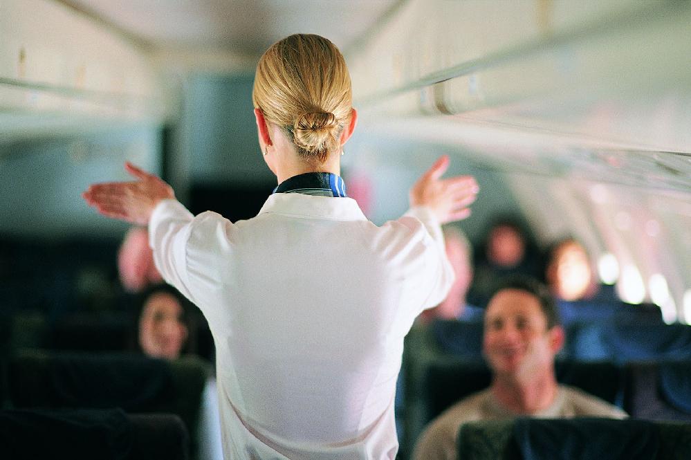 Flight Attendant giving directions (James Lauritz-Digital Vision-Getty Images) 