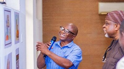 CARTAN President Dada Adekola talks through cartoons on display to one of Nigeria's foremost artists and painters, Kolade Oshinowo