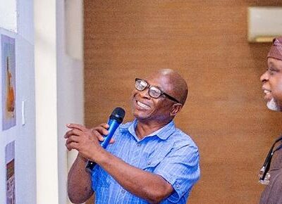 CARTAN President Dada Adekola talks through cartoons on display to one of Nigeria's foremost artists and painters, Kolade Oshinowo