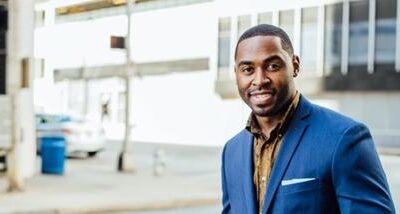 Black businessman in blue suit - photo via Unsplash
