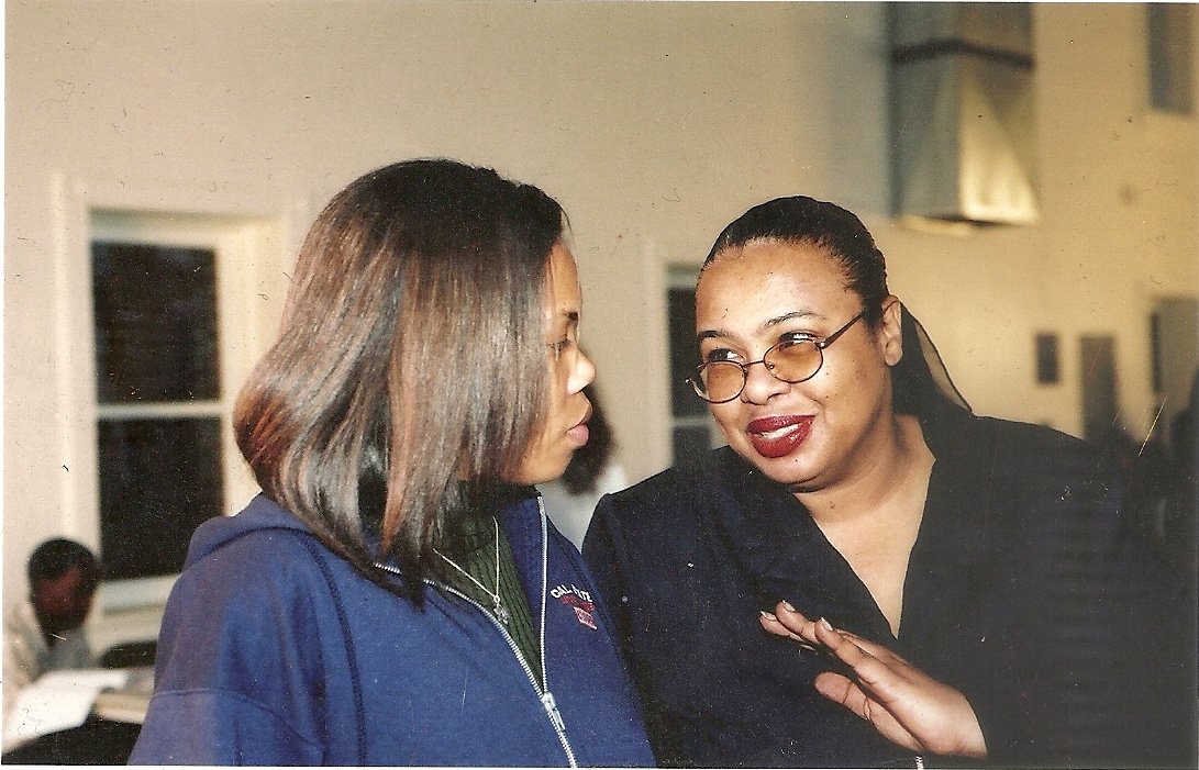 Dr. https://eurweb.com/wp-content/uploads/2024/05/NoahHaiduTrio_BusterWilliams_NoahHaidu_LennyWhite-1.jpg overseeing an event, talking with her assistant Dr. Kerri Moseley-Hobbs.