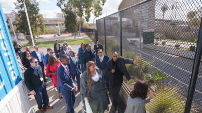 Kevin Murray, former California state senator and the president and CEO of the Weingart Center Association points out the fencing security at the Hilda L. Solis Care First Village. Mayors from across the country, including the youngest mayor in America Jaylen Smith (pinstripe suit and red tie) of Earle, Arkansas. Los Angeles, Ca., Photo by Solomon O. Smith