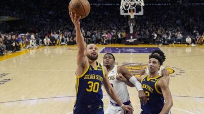 Steph Curry going to the hoop against Lakers (Ashley Landis-AP via CNN Newsource)