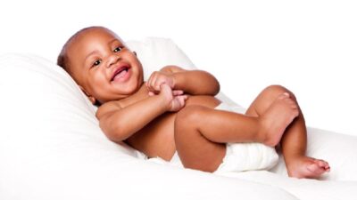 Black infant (wearing diaper) - Depositphotos