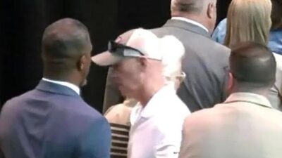 Dr Rainey Briggs being pushed away from white graduate by father - screenshot