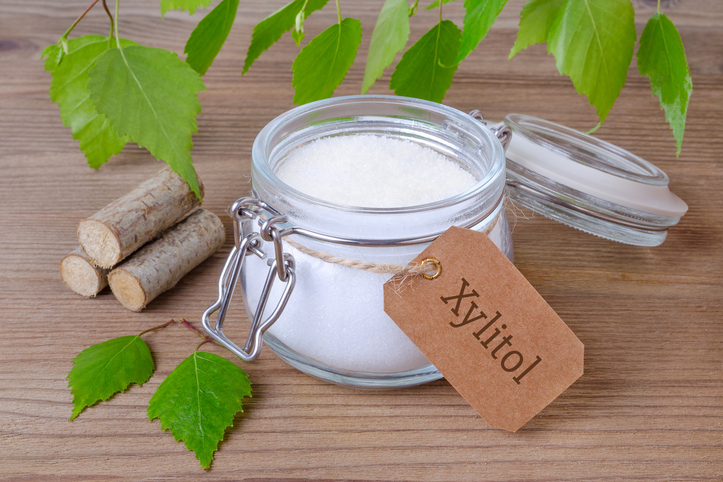 Sugar substitute xylitol, a glass jar with birch sugar, liefs and wood stock photo