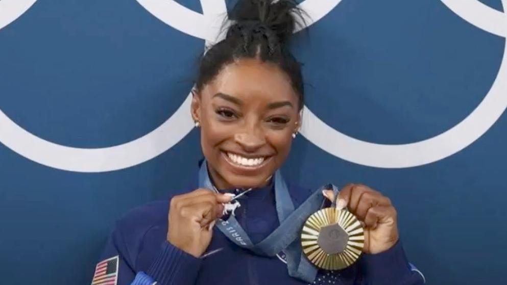 Simone Biles Named Sports Illustrated's Sportsperson 2024 // Simone Biles with gold medal - YouTube screenshot