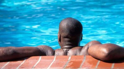 African American male swimmer in pool - Depositphotos
