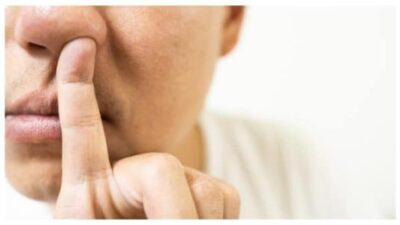 Young man is picking his nose
