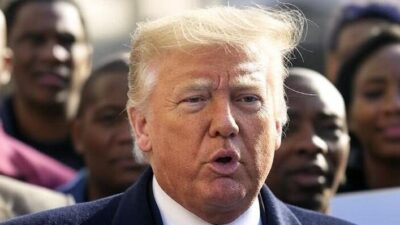 Donald Trump in front of African Americans - via Grok