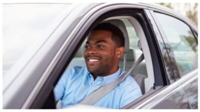 Happy male driver in car