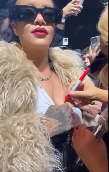 Marian Carey signs Rihana's breast