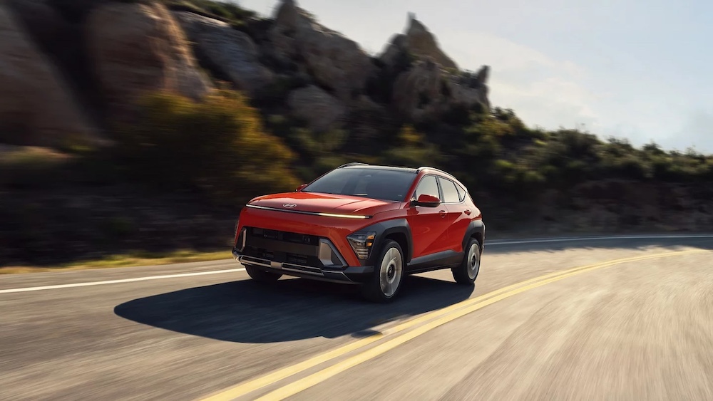 Hyundai’s Kona upgrade still impresses with sporty fun // red 2025 kona driving along a road