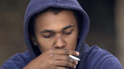 African American male smoking cigarette - Depositphotos