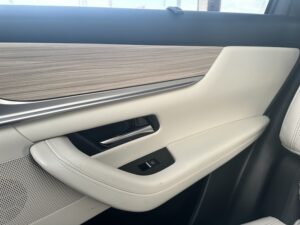 2025 Mazda CX-90 offers style, comfort & powerful trim options // side paneling of Mazda cx-90 - light wood grain with cream leather
