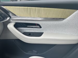 2025 Mazda CX-90 offers style, comfort & powerful trim options // Side paneling of Mazda CX- 90; customizable with light texture and gray cloth