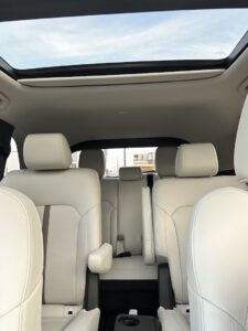 moon roof; open aisle in center rear passenger area, with retractable two cup cup holder