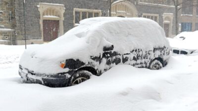 Car covered by snow after NYC snowstorm - Depositphotos
