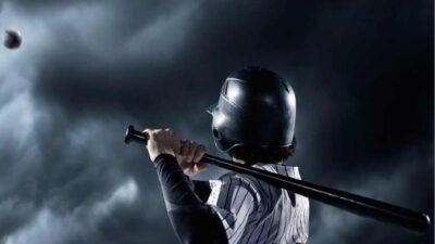Young baseball player at bat - via Canva.com